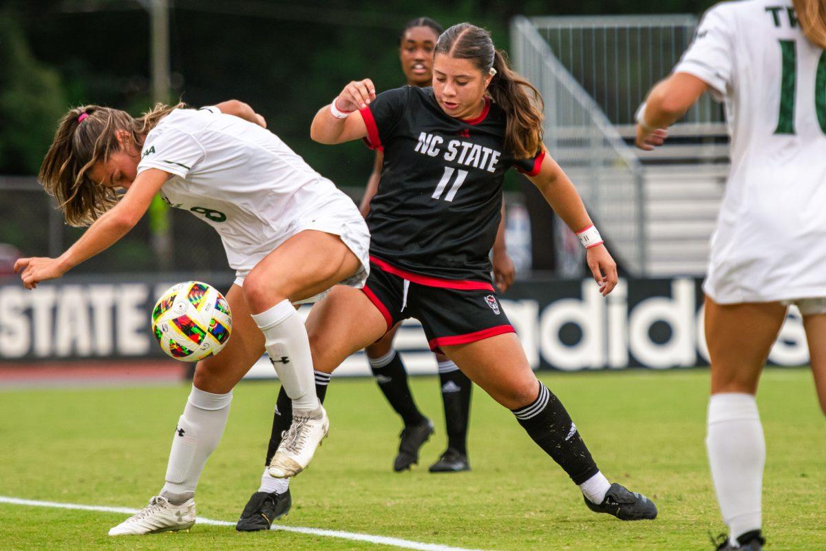 Senior defender Fernanda Soto pushes her opponent over the sideline while fighting for possession during the match against William &amp; Mary on Thursday, Sept. 12, 2024 at Dail Soccer Field. NC State lost 1-0.