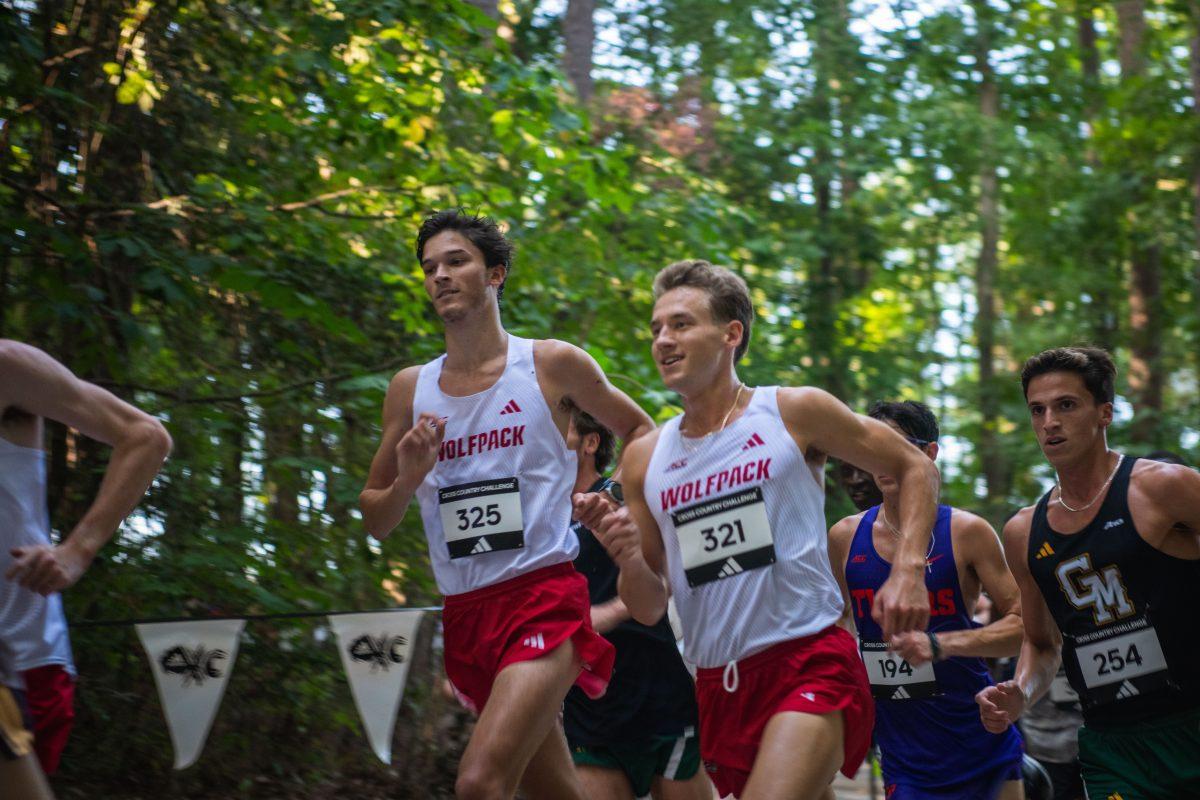 Graduates JJ Malach (left) and Brett Gardner (right) smile as they race during the Adidas XC Challenge at WakeMed Soccer Park on Friday, Sept. 20, 2024. Malach finished with a time of 18:05.5 and Gardner finished in first place with a time of 17:37.2. The NC State men's team finished in second place with a total of 51 points.