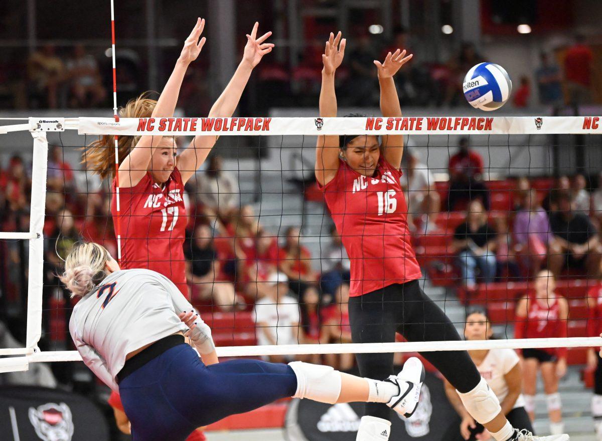 Senior opposite Amanda Rice and Senior middle blocker Jada Allen jump to block the ball during the match against Virginia in Reynolds Coliseum on Sunday, Sept. 29, 2024. Rice and Allen each had one ace. The Wolfpack beat the Cavaliers 3-1.