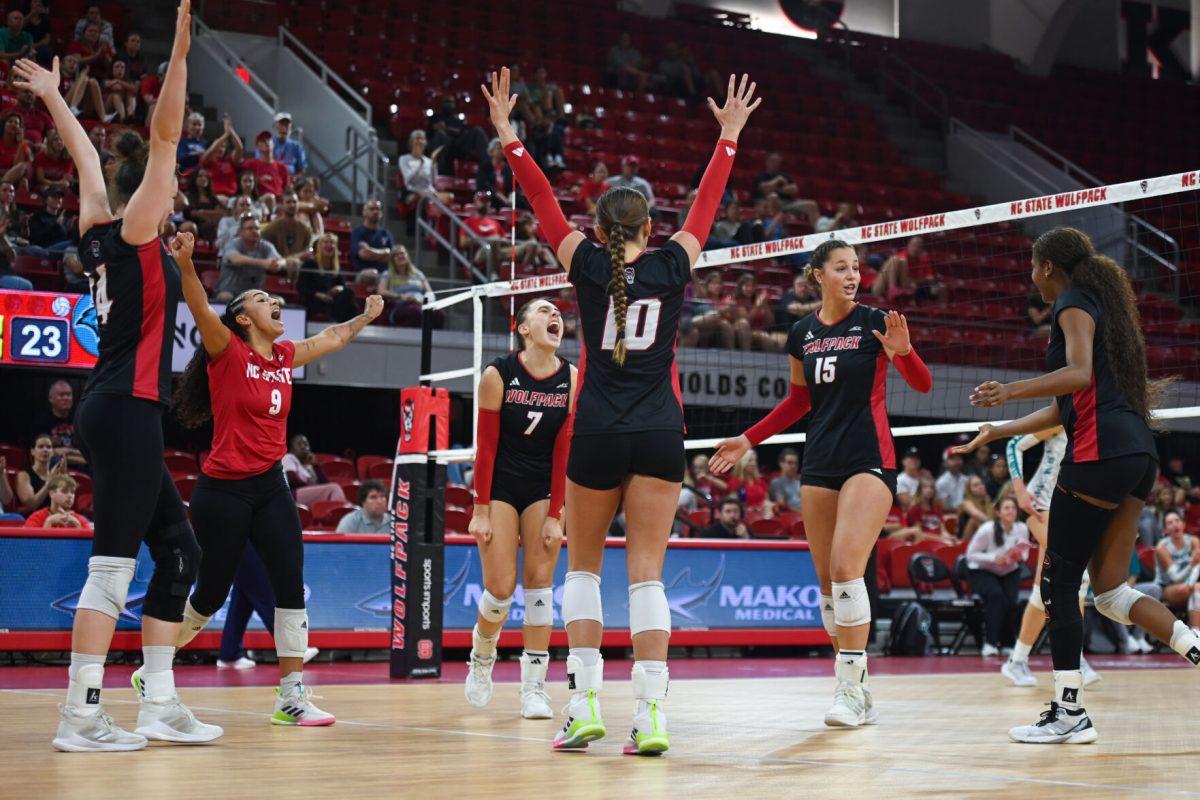 The NC State volleyball team celebrates a point scored during the game against Coastal Carolina in Reynolds Coliseum on Sunday, Sept. 22, 2024. The Wolfpack lost to the Chanticleers 3-2.