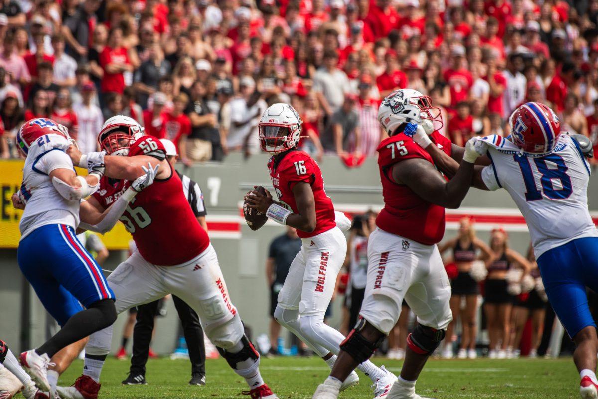 Freshman quarterback C.J. Bailey looks for an open pass while being defended during the game against LA Tech at Carter-Finley Stadium on Saturday, Sept. 14, 2024. Bailey had 156 passing yards during the game. The Wolfpack beat the Bulldogs 30-20.