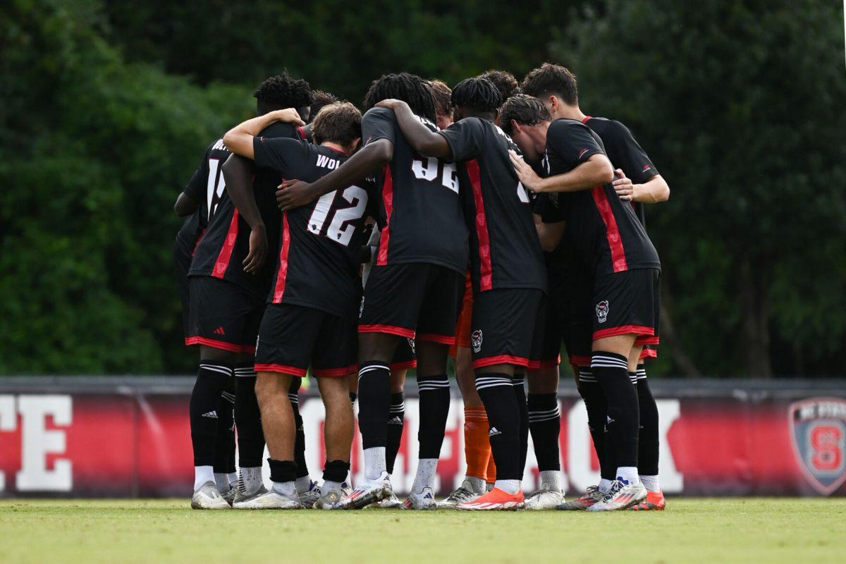 The NC State Wolfpack men's soccer team huddles together before their home game versus the Stetson Hatters at Dail soccer Field on Friday, Sept. 13. 2024. The Wolfpack went on to tie the Hatters 1-1.