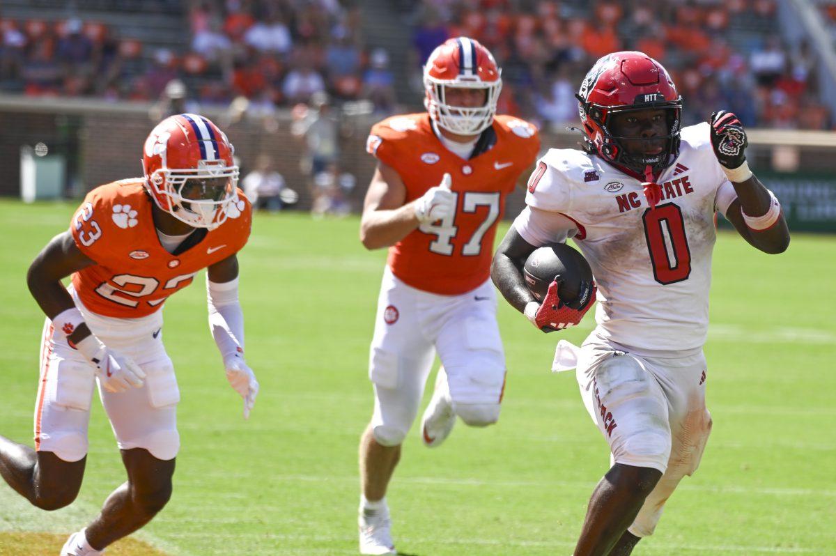 Sophomore running back Kendrick Raphael dodges the opposing team during the football game against Clemson in Memorial Stadium on Saturday, Sept. 21, 2024. Raphael rushed for 94 yards and scored one touchdown.&#160;Clemson beat NC State 59-35.