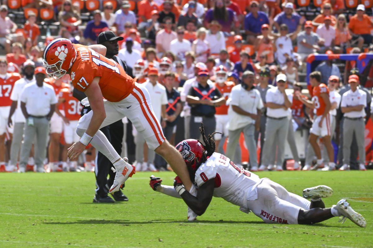 Redshirt junior Sean Brown grabs his opponent's leg during the football game against Clemson in Memorial Stadium on Saturday, Sept. 21, 2024. Brown had five tackles total and one sack.&#160;Clemson beat NC State 59-35.