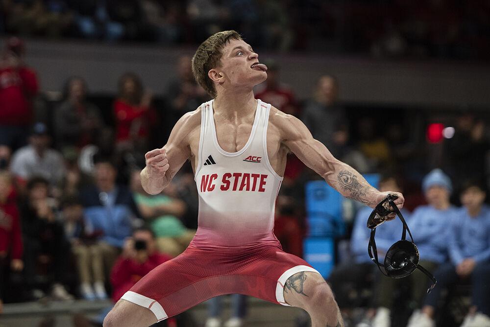 Redshirt junior Kai Orine celebrates winning his bout after the duel against UNC-Chapel Hill in Reynolds Coliseum on Friday, Feb. 2, 2024. Orine won the 133 bout by technical fall. The Wolfpack beat the Tar Heels 33-6.