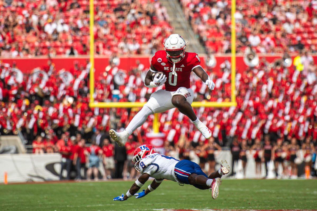Sophomore running back Kendrick Raphael hurdles over the defender during the game against LA Tech at Carter-Finley Stadium on Saturday, Sept. 14, 2024. Raphael had 63 rushing yards and scored one touchdown during the game. The Wolfpack beat the Bulldogs 30-20.