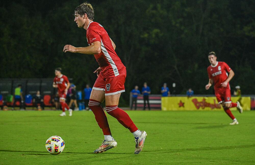 Graduate defender Liam Bennett dribbles the ball during the match against Duke University at Dail Soccer Field on Friday, Sept. 27, 2024. NC State lost to Duke 2-1.