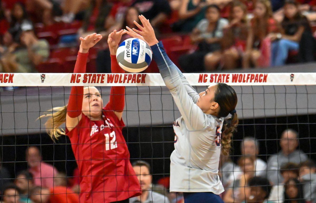 Junior outside hitter Courtney Bryant blocks the ball during the match against Virginia in Reynolds Coliseum on Sunday, Sept. 29, 2024. Bryant had 11 digs and nine kills. The Wolfpack beat the Cavaliers 3-1.