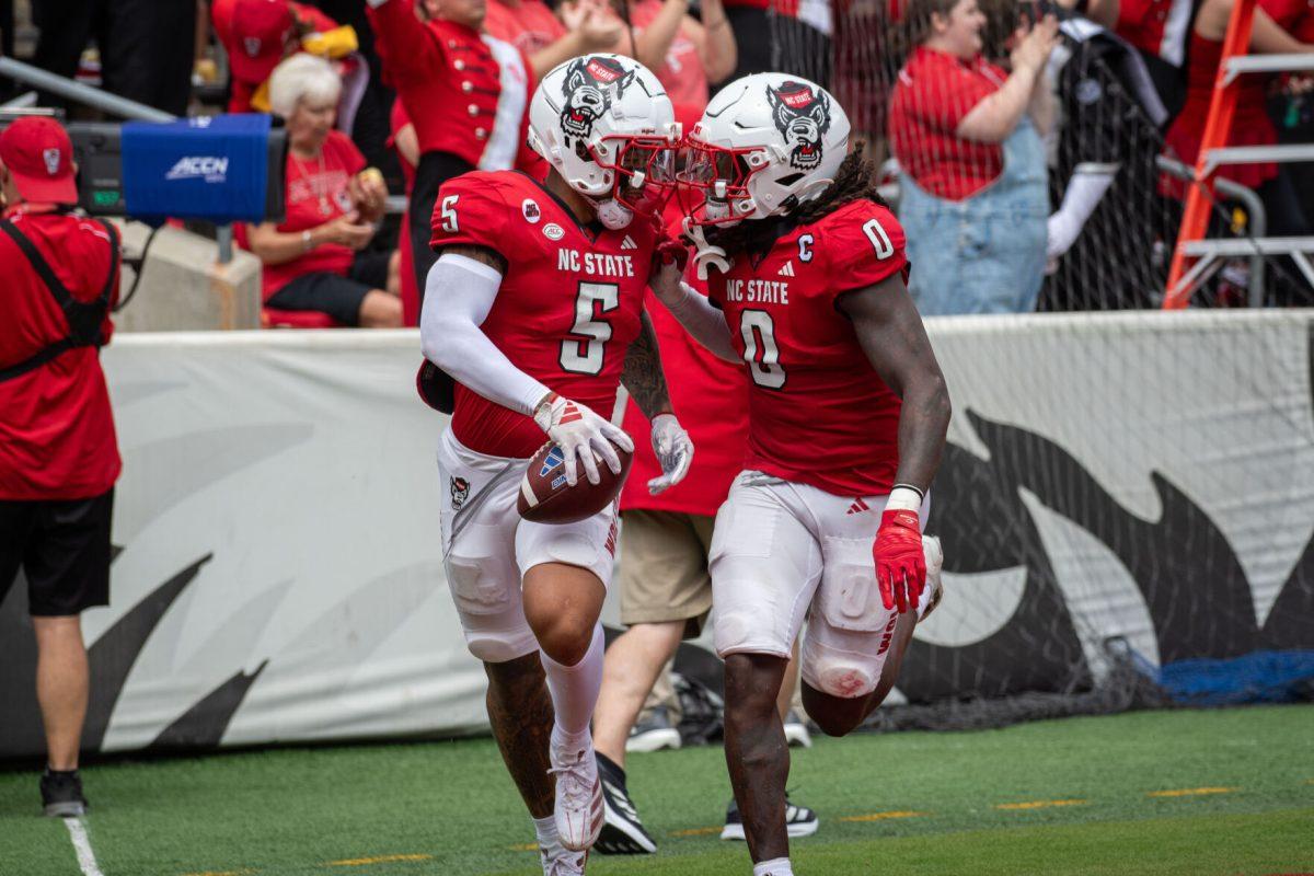 Senior safety DK Kaufman (left) celebrates with redshirt junior linebacker Sean Brown (right) after scoring a touchdown during the game against LA Tech at Carter-Finley Stadium on Saturday, Sept. 14, 2024. Kaufman had three tackles and scored one touchdown during the game. The Wolfpack beat the Bulldogs 30-20.