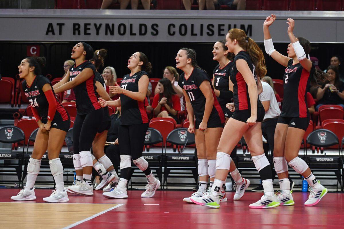 The NC State volleyball team celebrates a point scored during the game against Coastal Carolina in Reynolds Coliseum on Sunday, Sept. 22, 2024. The Wolfpack lost to the Chanticleers 3-2.