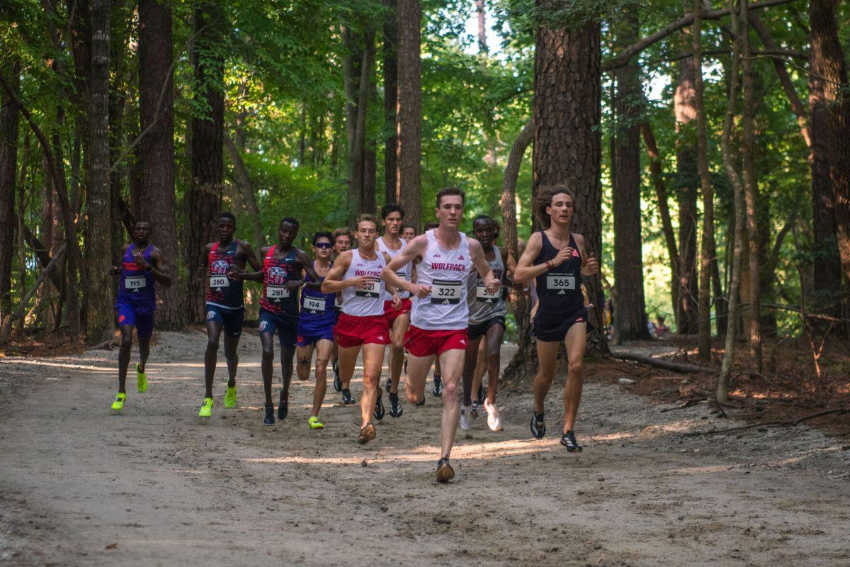 The NC State men's team leads the pack through the woods during the Adidas XC Challenge at WakeMed Soccer Park on Friday, Sept. 20, 2024. The NC State men's team finished in second place with a total of 51 points.