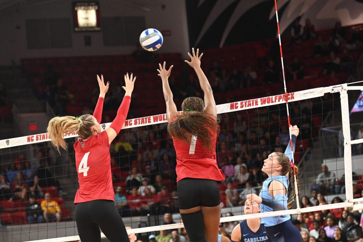 Senior outside hitter Madison Williams and junior middle blocker Sophie Groom attempt to block the ball during the match against UNC-Chapel Hill on Friday, Oct. 11, 2024. The Wolfpack defeated the Tar Heels 3-1.