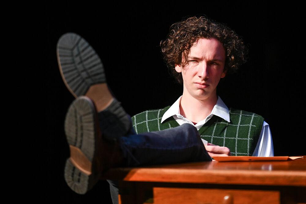 Luke Moran, a first-year studying biology, sits at a table onstage during the dress rehearsal of "Teletype" in Kennedy-McIlwee Studio Theater on Wednesday, Oct. 2, 2024. Moran performed as the character Lindsey Neely.