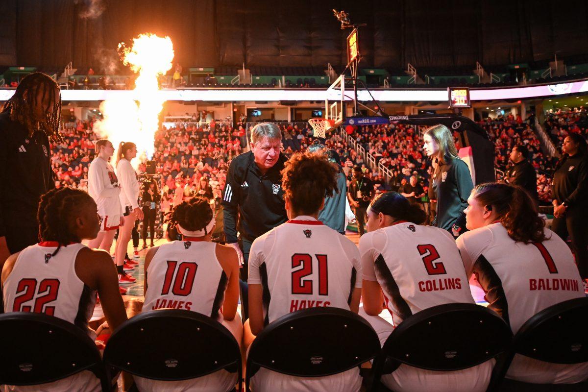 NC State head coach Wes Moore talks to the starting lineup before the ACC Tournament semifinals game against Florida State in Greensboro Coliseum on Saturday, March 9, 2024. NC State beat Florida State 69-43.