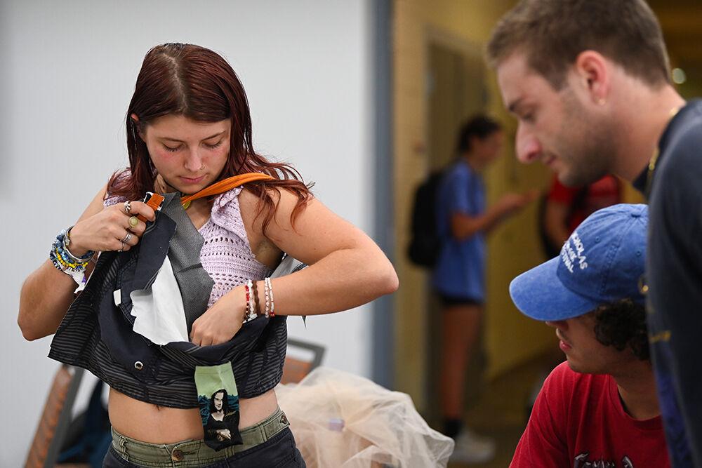 Evie Dalamn, a third-year studying biology, tries on the costume she is working on at Spooky Stitches at Witherspoon Student Center on Thursday, Oct. 24, 2024. Spooky Stitches was an event organized by the Sustainability Stewards where students could make Halloween costumes out of reused textiles and clothing.