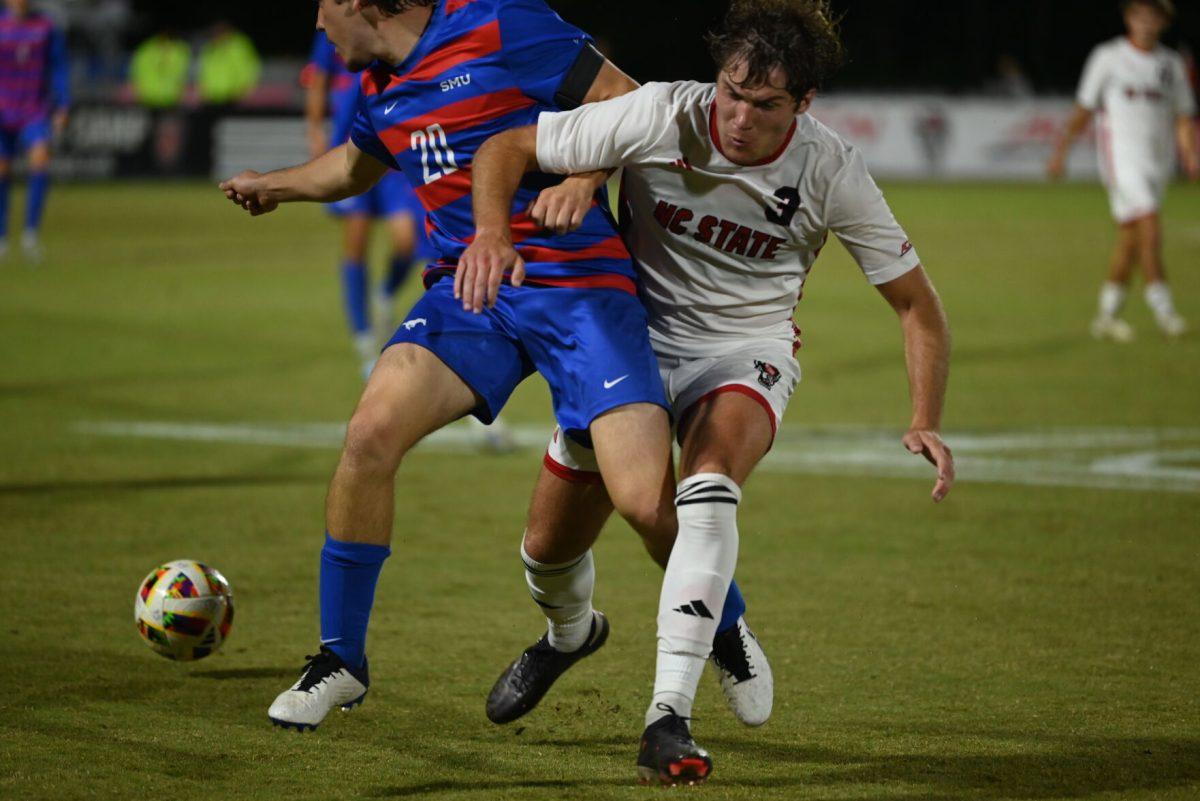 Graduate defender Liam Bennett attemps to strip the ball from the SMU offense at Dail Soccer Field on Saturday, Oct. 19, 2024. NC State beat SMU 5-1.