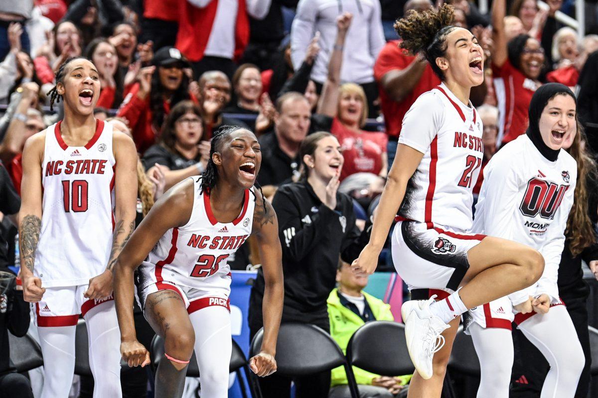 The NC State bench celebrates during the ACC Tournament semifinals game against Florida State in Greensboro Coliseum on Saturday, March 9, 2024. NC State beat Florida State 69-43.