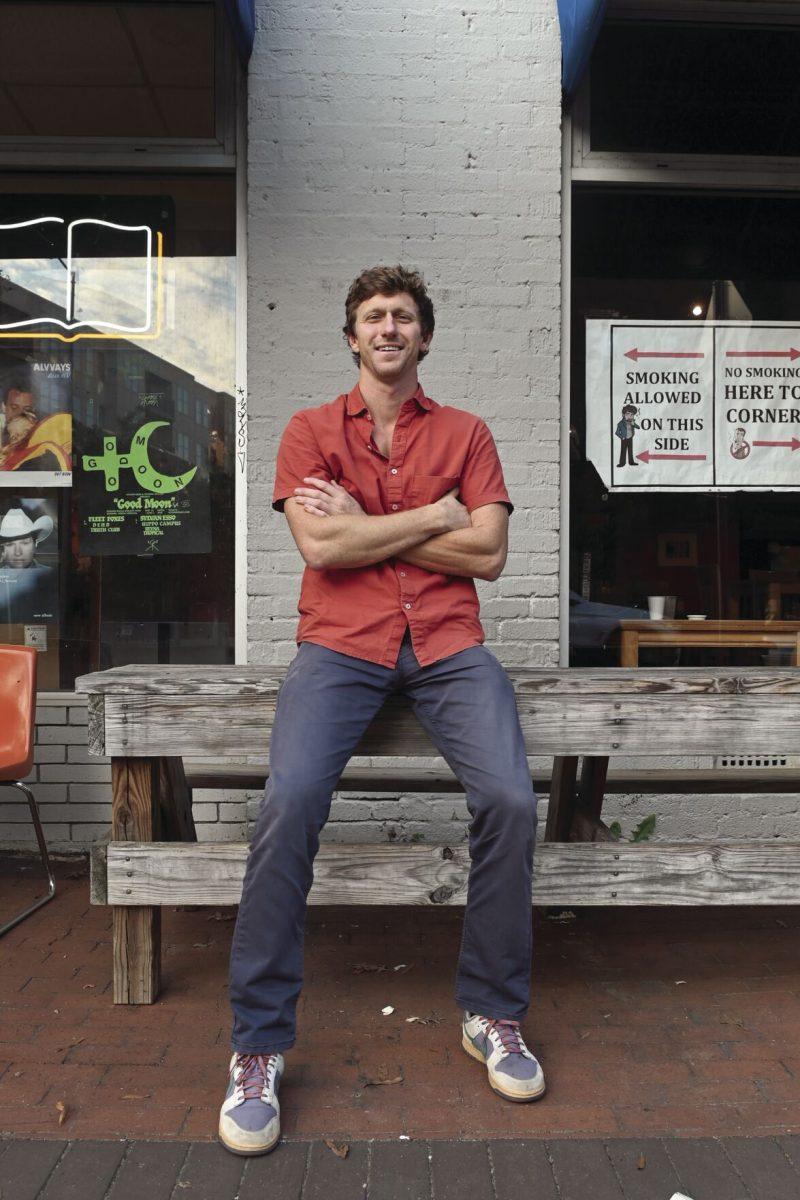 Reeves Peeler, a candidate running for an at-large seat on Raleigh City Council in 2024, sits outside of Cup A Joe on Hillsborough Street on Thursday, Oct. 3, 2024. Peeler&#8217;s hope is to build a future where Raleigh is affordable, green, walkable, safe and a place where everyone can thrive.