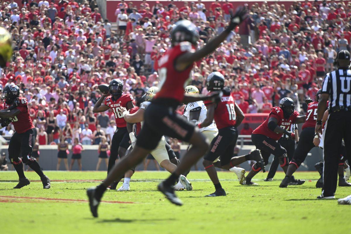 Freshman quarterback CJ Bailey looks for an opening during the football game against Wake Forest in Carter-Finley Stadium on Saturday, Oct. 5, 2024. Bailey scored two touchdowns and passed for 272 total yards. NC State lost to Wake Forest 34-30.