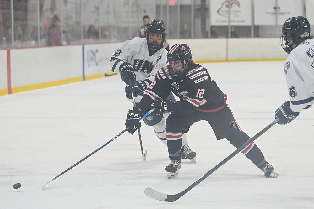 Junior forward Aiden Brenner leaps for the puck during the game against the University of New Hampshire at Invisalign Arena on Friday, Oct. 18th. The Wolfpack lost to the Wildcats 4-3.