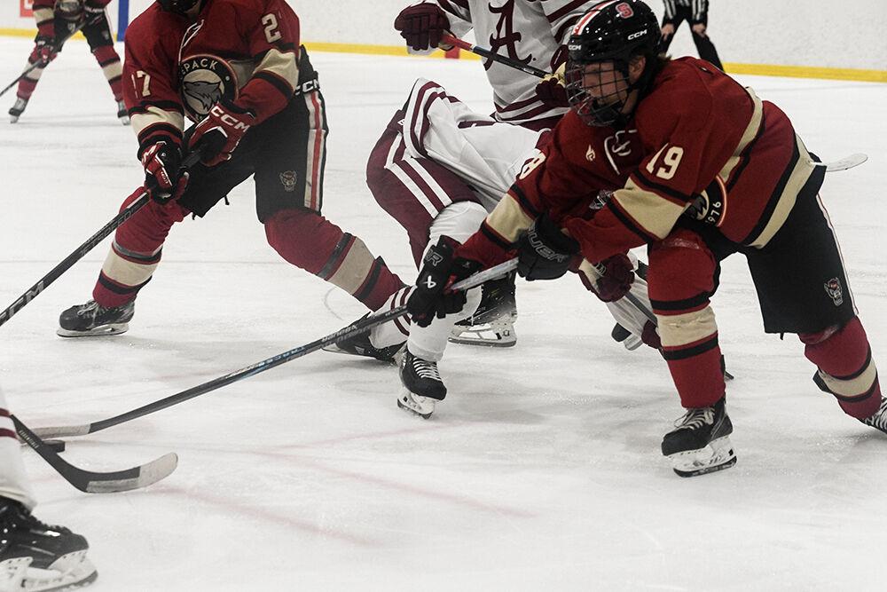 Freshman forward Reece Johnson reaches for the puck during match against Alabama in Invisalign Arena on Saturday, Oct. 5, 2024. Johnson scored on assist. NC State beat Alabama 5-2.