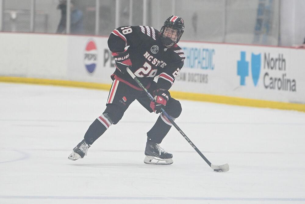 Sophmore forward Jake Gifford looks to make a pass during the game against the University of New Hampshire at Invisalign Arena on Friday, Oct. 18, 2024. The Wolfpack lost to the Wildcats 4-3.