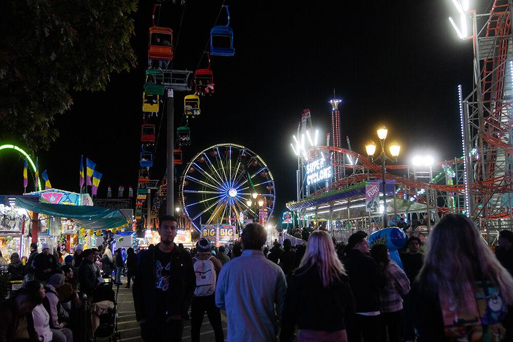 Fairgoers walk through the Powers Great American Midways during the North Carolina State Fair in Raleigh on Sunday, Oct. 27, 2024. The State Fair lasted Oct. 17-27. Powers Great American Midways is where all the most popular rides at the NC State Fair are located.