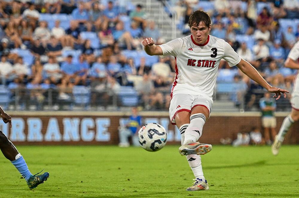 Graduate defender Liam Bennett passes the ball to a teammate during the match against UNC-Chapel Hill at Dorrance Field on Friday, Sept. 20, 2024. NC State lost to UNC-Chapel Hill 2-0.