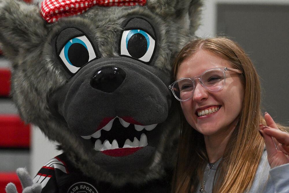 Ms. Wuf (left) and Shelby Miller (right) pose for a photo between periods during the game against UNC-Chapel Hill at Invisalign Arena on Friday, Oct. 11, 2024. UNC-Chapel Hill defeated NC State 6-5.