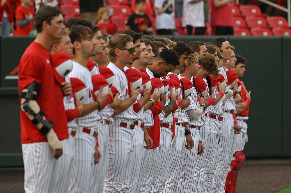 NC State's baseball team stands for the National Anthem before the game against Elon on Wednesday, Oct. 9, 2024 at Doak Field at Dail Park. NC State defeated Elon 20-4.