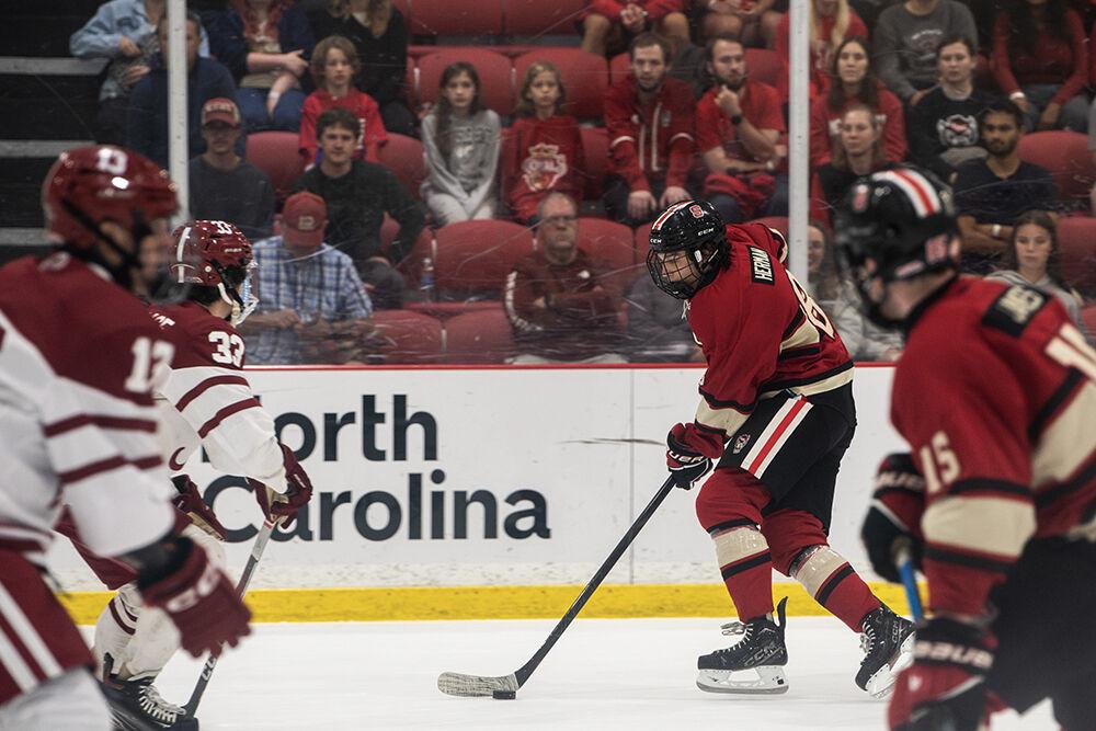 Junior center Zach Herman dribbles the puck during the match against Alabama at the Invisalign Arena on Saturday, Oct. 5, 2024. Herman made one assist. The Wolfpack defeated the Crimson Tide 5-2.