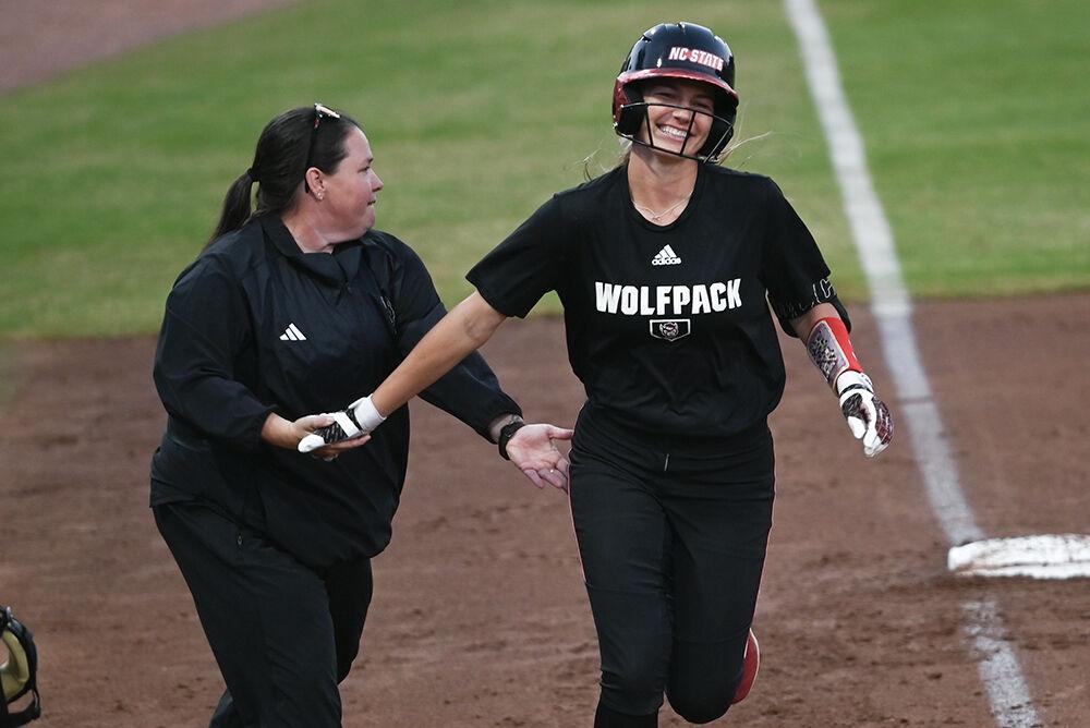 Head coach Lindsay Leftwich congratulates senior infielder Taylor Ensley after she hits a home run during the game against Elon at Dail Softball Stadium on Wednesday, Oct. 23, 2024. The Wolfpack won the game 14-7.