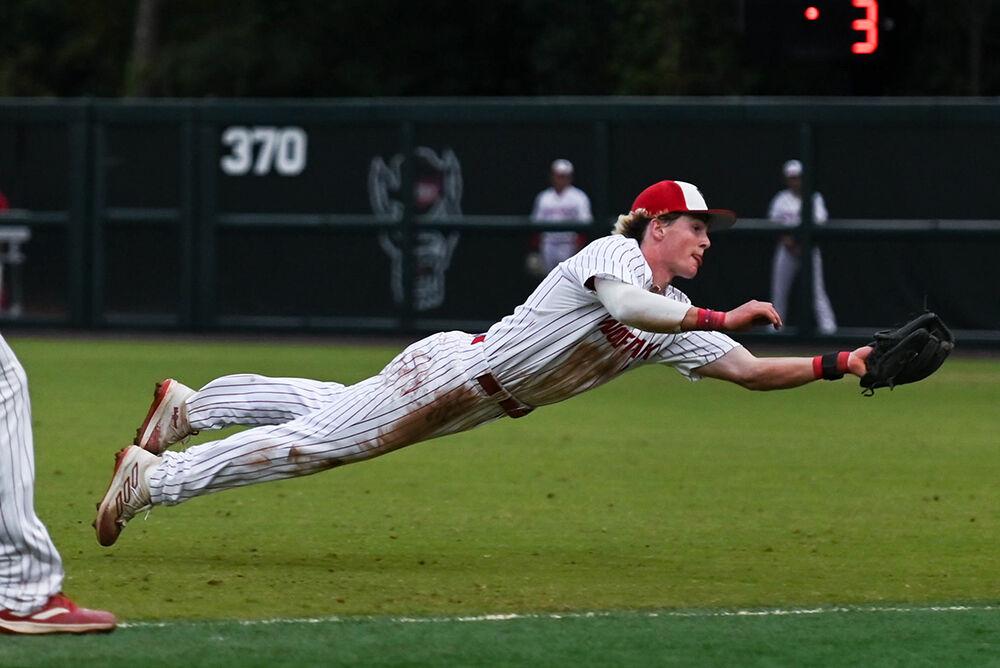 Sophomore infielder Luke Nixon dives to catch the ball during the game against Elon at Doak Field at Dail Park on Wednesday, Oct. 9, 2024. NC State beat Elon 20-4 to win the fall&#160;game at their home stadium.