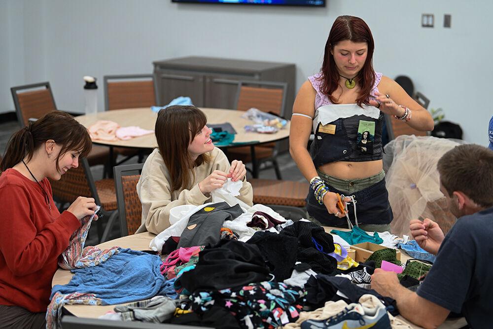 Kelly Burger, a second-year studying aerospace engineering, Georgia Moorefield, a first-year studying psychology, and Evie Dalamn, a third-year studying biology, work on their costumes at Spooky Stitches at Witherspoon Student Center on Thursday, Oct. 24, 2024. Spooky Stitches was an event organized by the Sustainability Stewards where students could make Halloween costumes out of reused textiles and clothing.