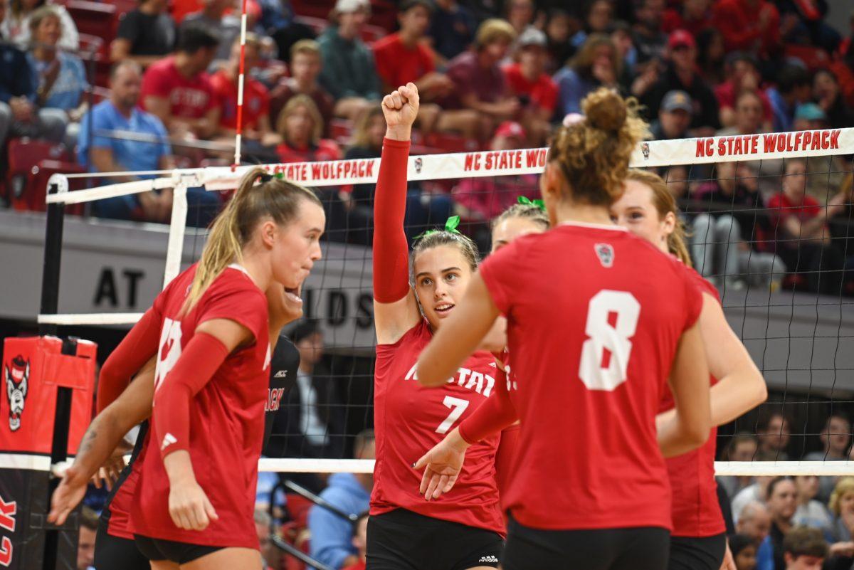 The NC State volleyball team celebrates after earning a point during the volleyball match against UNC-Chapel Hill on Friday, Oct. 11, 2024. The Wolfpack defeated the Tar Heels 3-1.