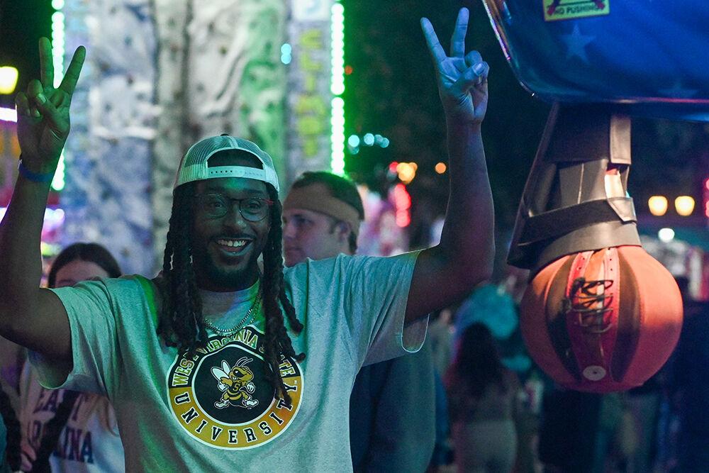 Fairgoer Mark Pressley holds up two peace signs in front of a boxing simulator game at the North Carolina State Fair in Raleigh&#160;on Thursday, Oct. 24, 2024.&#160;The fair was held from Oct. 17-27, 2024.