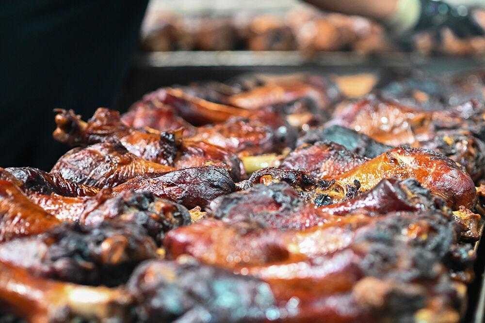 Turkey legs sizzle on the grill at the North Carolina State Fair in Raleigh&#160;on Thursday, Oct. 24, 2024. A staple of the fair&#8217;s culinary offerings, these smoked turkey legs attract visitors year after year with their hearty flavor and signature aroma, contributing to the festive atmosphere of one of the state&#8217;s largest annual events.