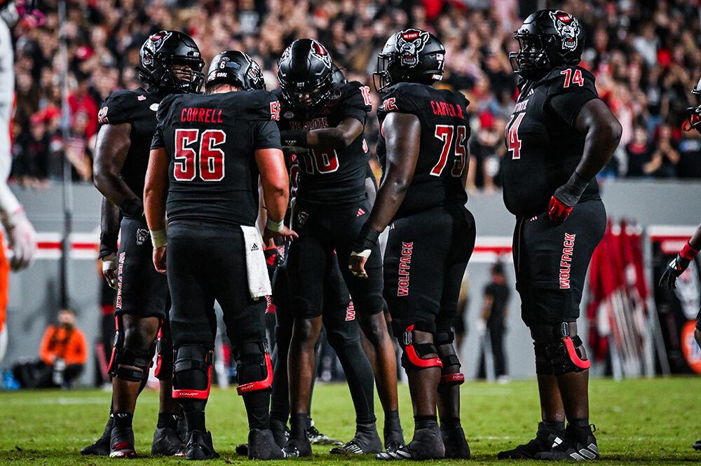 Freshman quarterback CJ Bailey reads a play to the lineman during the game against Syracuse in Carter-Finley Stadium on Saturday, Oct. 12, 2024. Bailey threw for 329 yards and two touchdowns. The Orange defeated the Wolfpack 24-17.