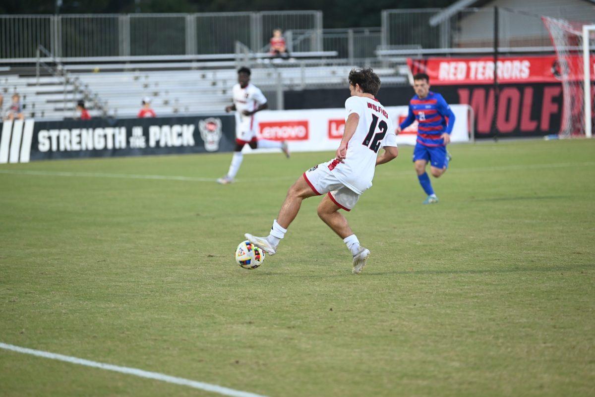 Junior center attacking midfielder Taig Healy dribbles the ball downfield during NC State's soccer game against SMU at Dail Soccer Field on Saturday, Oct. 19, 2024. NC State beat SMU 5-1.