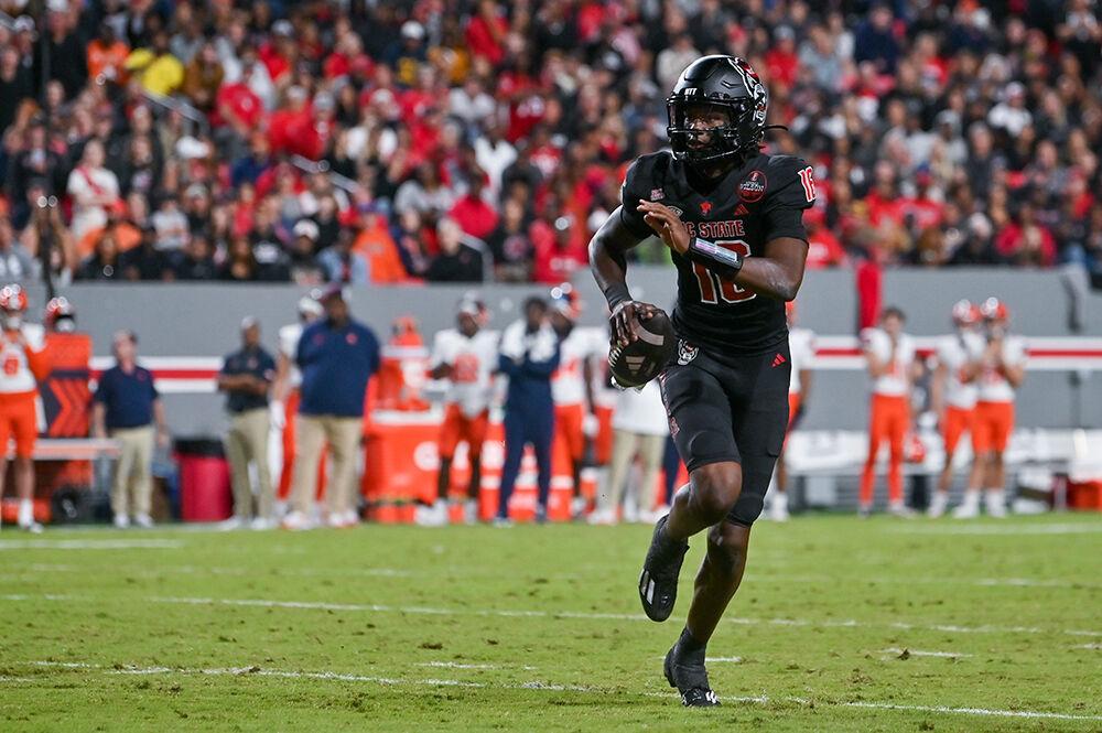 Freshman quarterback CJ Bailey looks to throw the ball during the game against Syracuse in Carter-Finley Stadium on Saturday, Oct. 12, 2024. Bailey threw for 329 yards and two touchdowns. The Orange defeated the Wolfpack 24-17.
