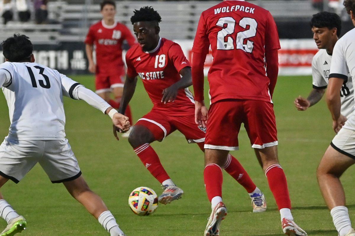 Senior defender Yves Tcheuyap dribbles up the field during the Wolfpack's final home soccer game of the regular season against the Louisville Cardinals at Dail Soccer Field on Sunday, Oct. 27, 2024. The Wolfpack beat the Cardinals 1-0.