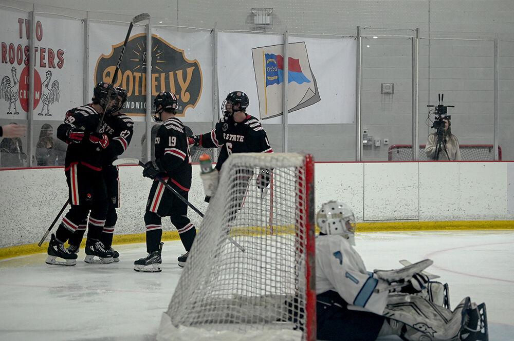 Sophomore forward Holden Koufman, sophomore forward Nick Shook, freshman forward Reece Johnson and senior defender Kade McConaghy celebrate a goal during the game against UNC-Chapel Hill at Invisalign Arena on Friday Oct. 11, 2024. NC State lost the game 6-5.