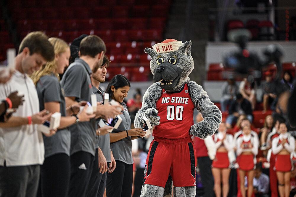 Mr. Wolf points at one of the rings of a NC State student during halftime during the exhibition&#160;game against Anderson in Reynolds Coliseum on Tuesday, Oct. 29, 2024. The Wolfpack beat the Trojans 91-54.