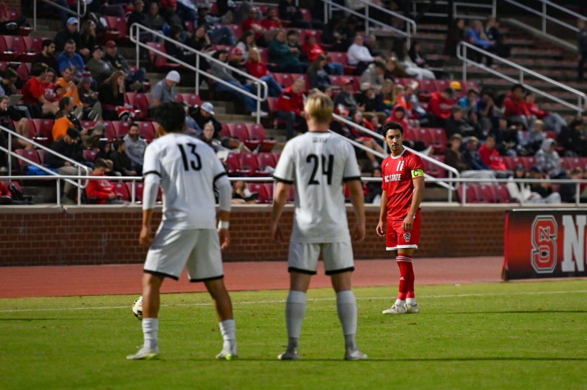 Senior midfielder/forward Henrique Santos lines up behind the ball and prepares to take a free kick during the game against Louisville at Dail Soccer Field on Sunday, Oct. 27, 2024. Santos scored the only goal of the match. NC State defeated&#160; Louisville 1-0.
