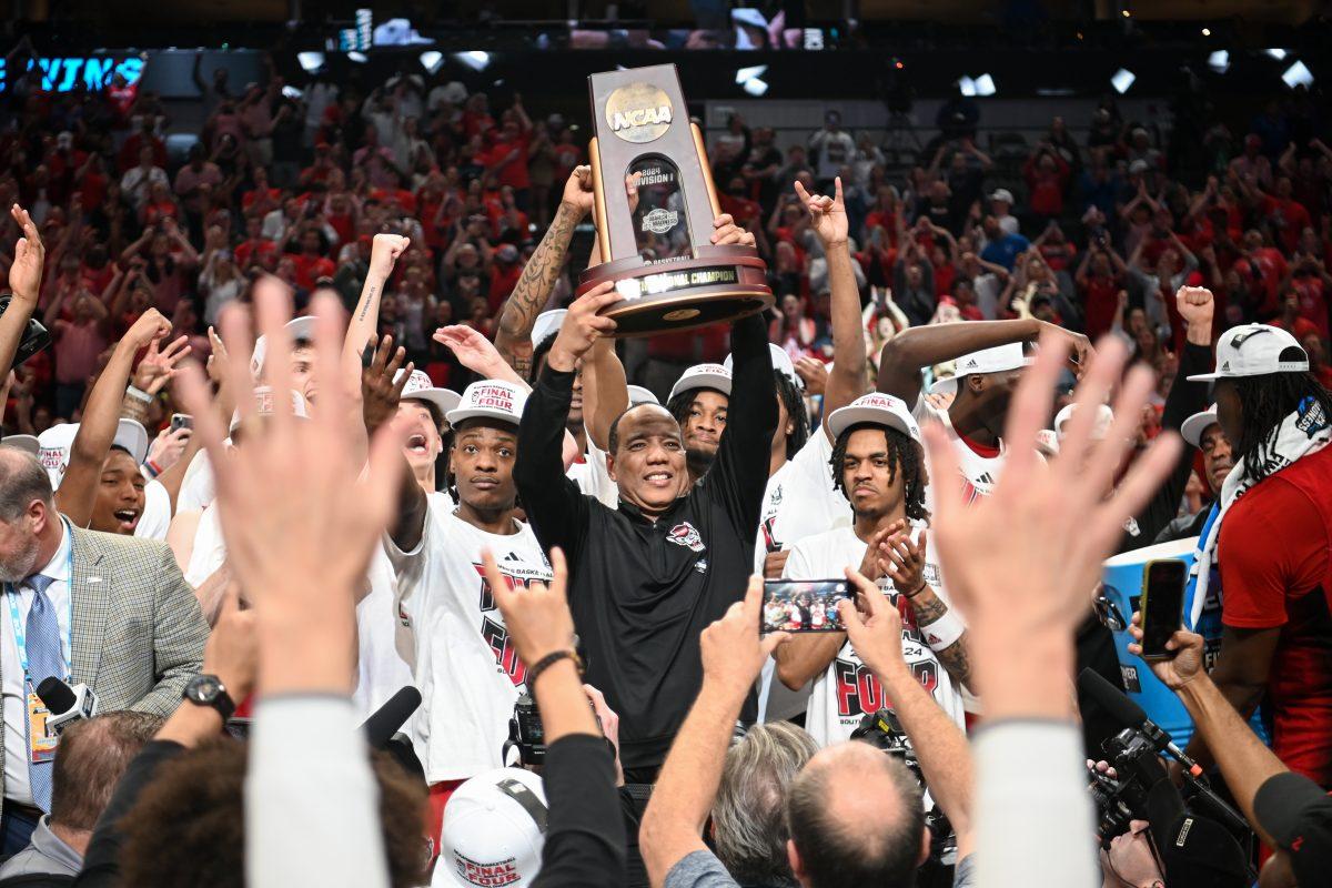 Head coach Kevin Keatts raises the South Regional Champions trophy after winning the NCAA Tournament Elite 8 game against Duke at American Airlines Center in Dallas on Sunday, March 31, 2024. Burns led in scoring with 29 points. NC State beat Duke 76-64 to advance to the Final Four.