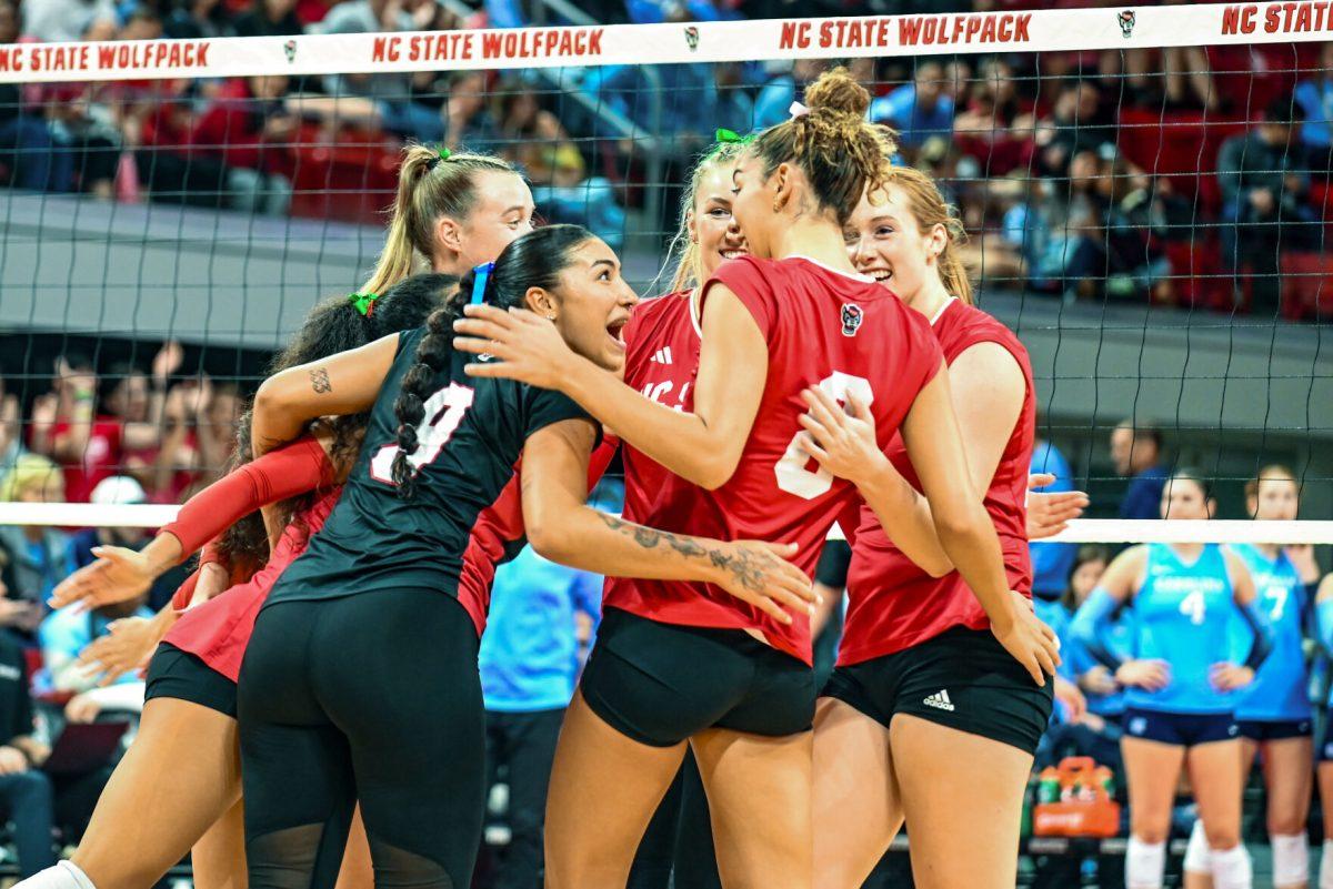 Gradute Libero Skye Stoke and the Wolfpack Volleyball team celebrate after earning a point during the volleyball match against UNC Chapel Hill on Friday, Oct. 11, 2024. The Wolfpack defeated the Tar Heels 3-1.