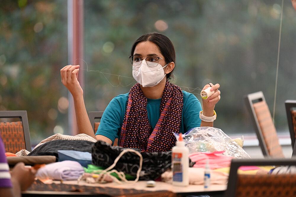 Shweta Patki pulls out thread at Spooky Stitches at Witherspoon Student Center on Thursday, Oct. 24, 2024. Spooky Stitches was an event organized by the Sustainability Stewards where students could make Halloween costumes out of reused textiles and clothing.