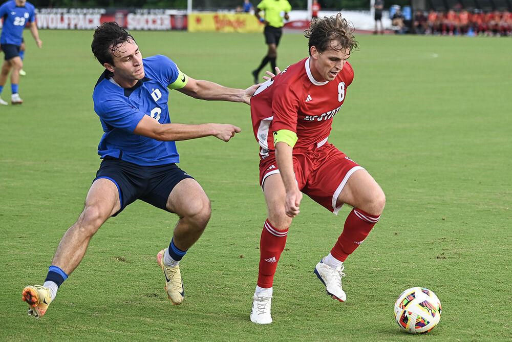 Senior midfielder Will Buete ignores his opponent's grasp during the match against Duke University at Dail Soccer Field on Friday, Sept. 27th, 2024. NC State lost to Duke 2-1.