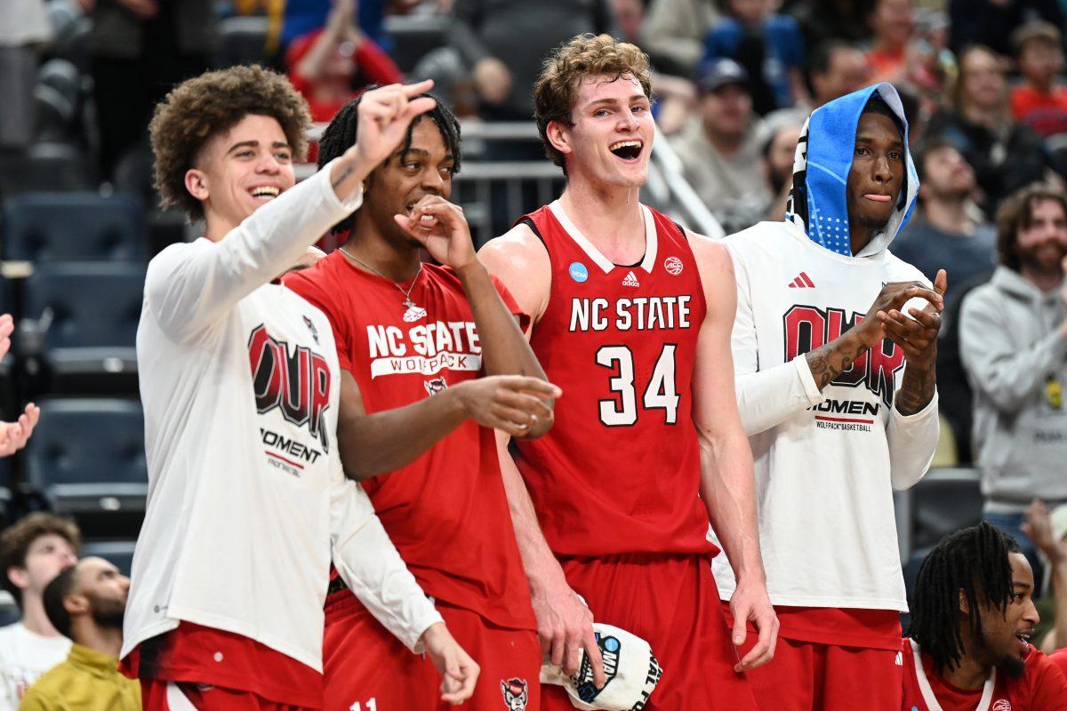 The NC State bench celebrates during the first round game of the NCAA Tournament against Texas Tech at PPG Paints Arena in Pittsburgh on Thursday, March 21, 2024. NC State beat Texas Tech 80-67.