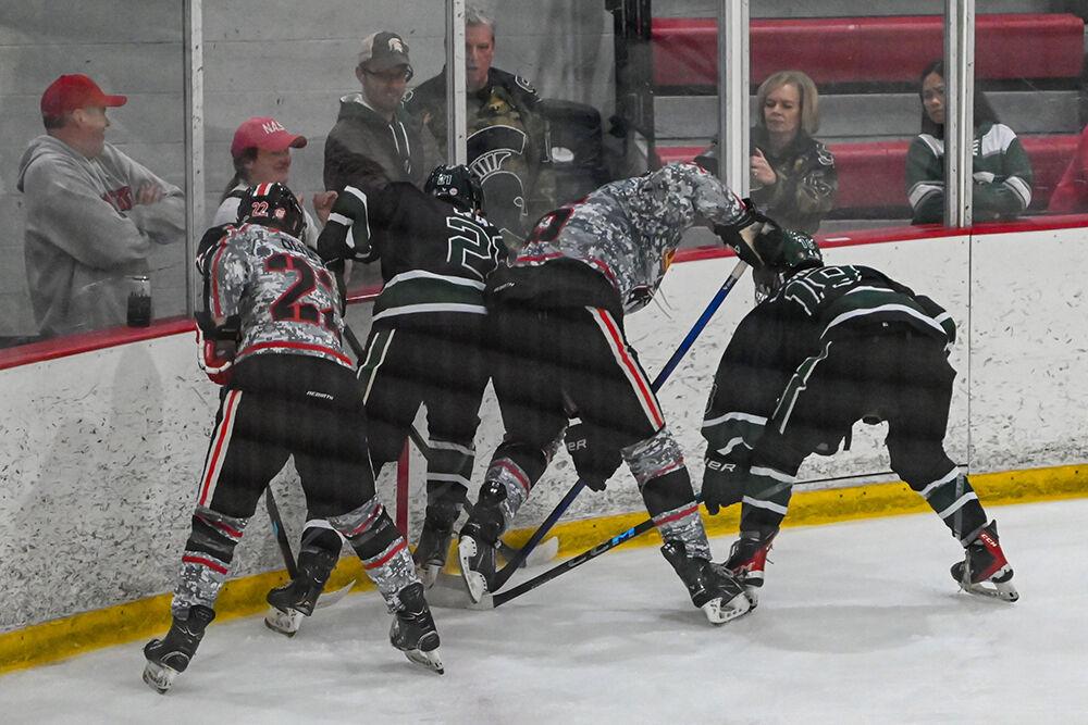 Senior forward Emery Oliver and freshman defender Tait Sawden battle for the puck during the game against Michigan State at the Invisalign Arena on Friday, Nov. 8, 2024. NC State beat Michigan State 4-2.